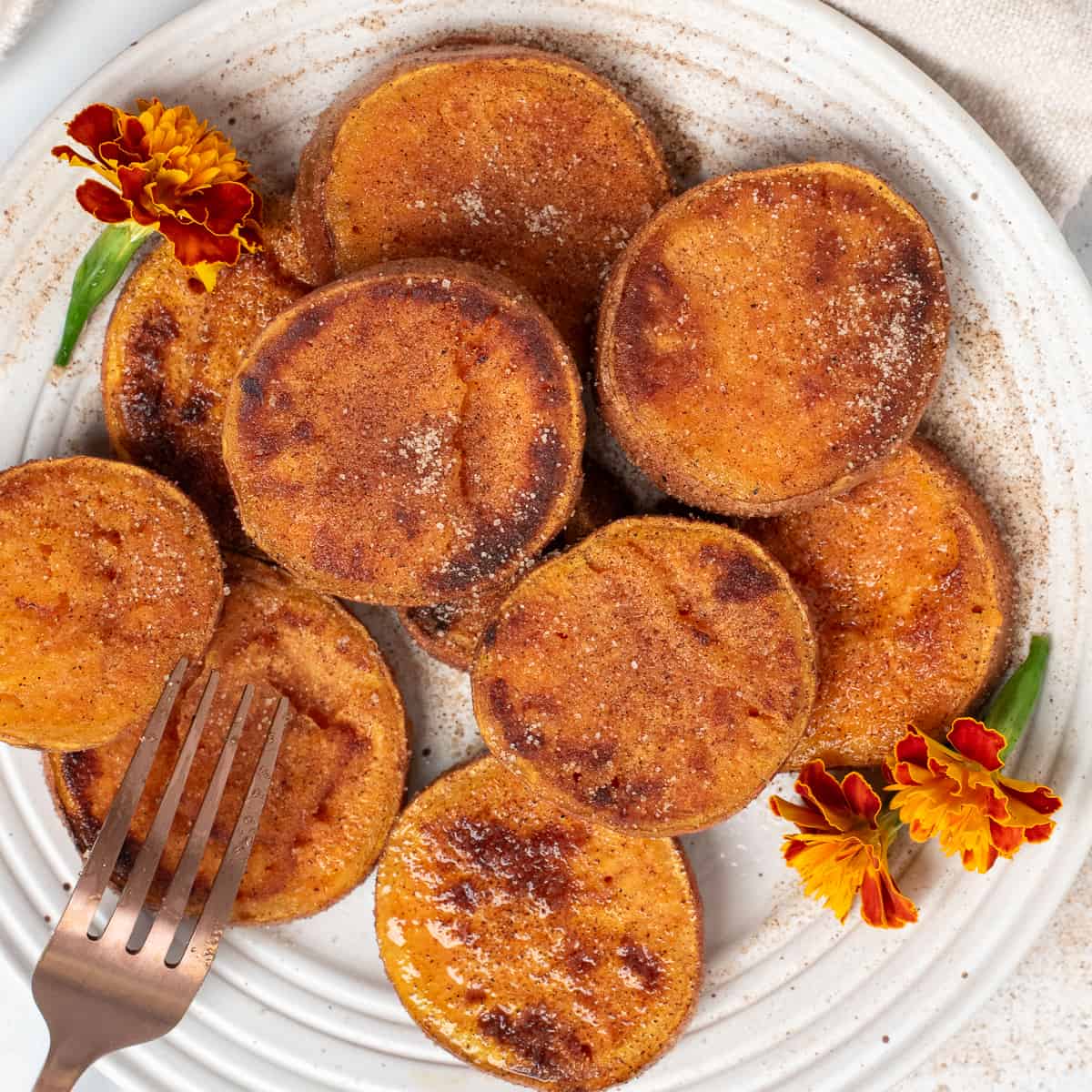 square image of pan friend sweet potatoes with small flowers.