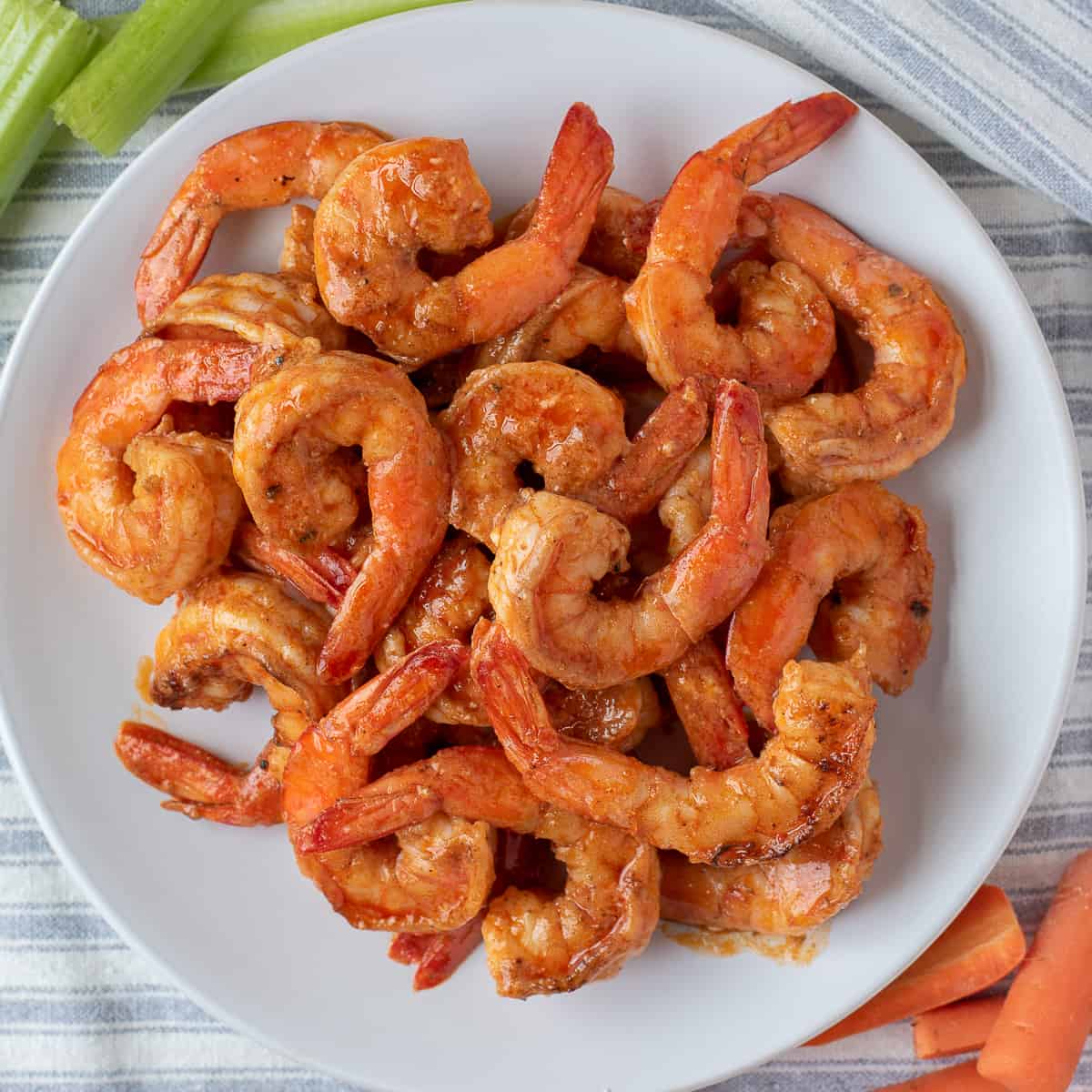 overhead shot of buffalo shrimp on plate.