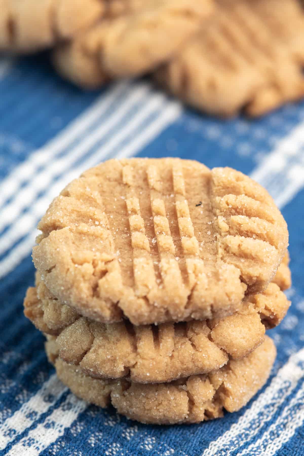 chewy peanut butter cookies on a blue and white linen