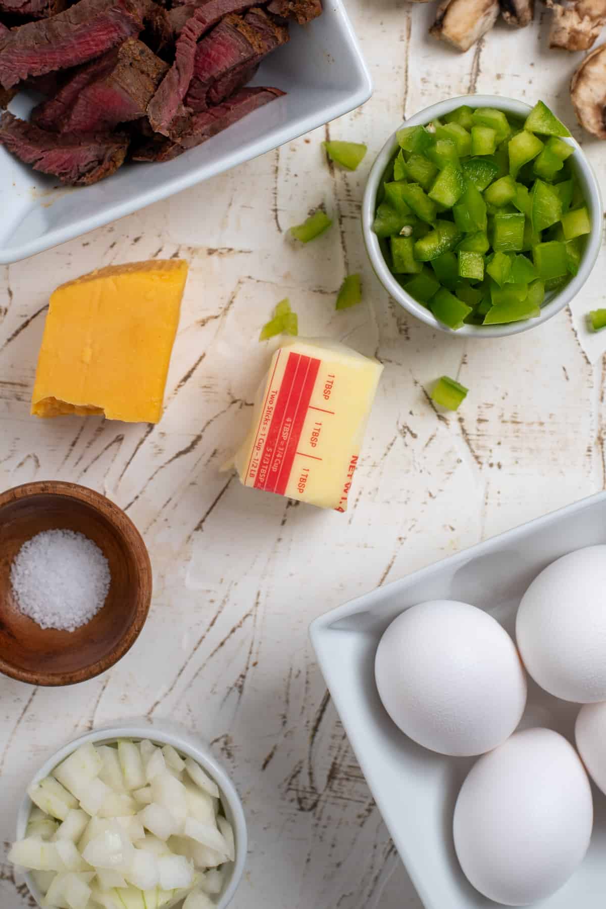 ingredients needed for steak omelette on a white background