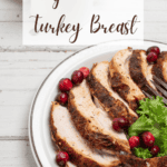 Cajun fried turkey breast, sliced on a white plate with fresh cranberries and the recipe title in a text overlay