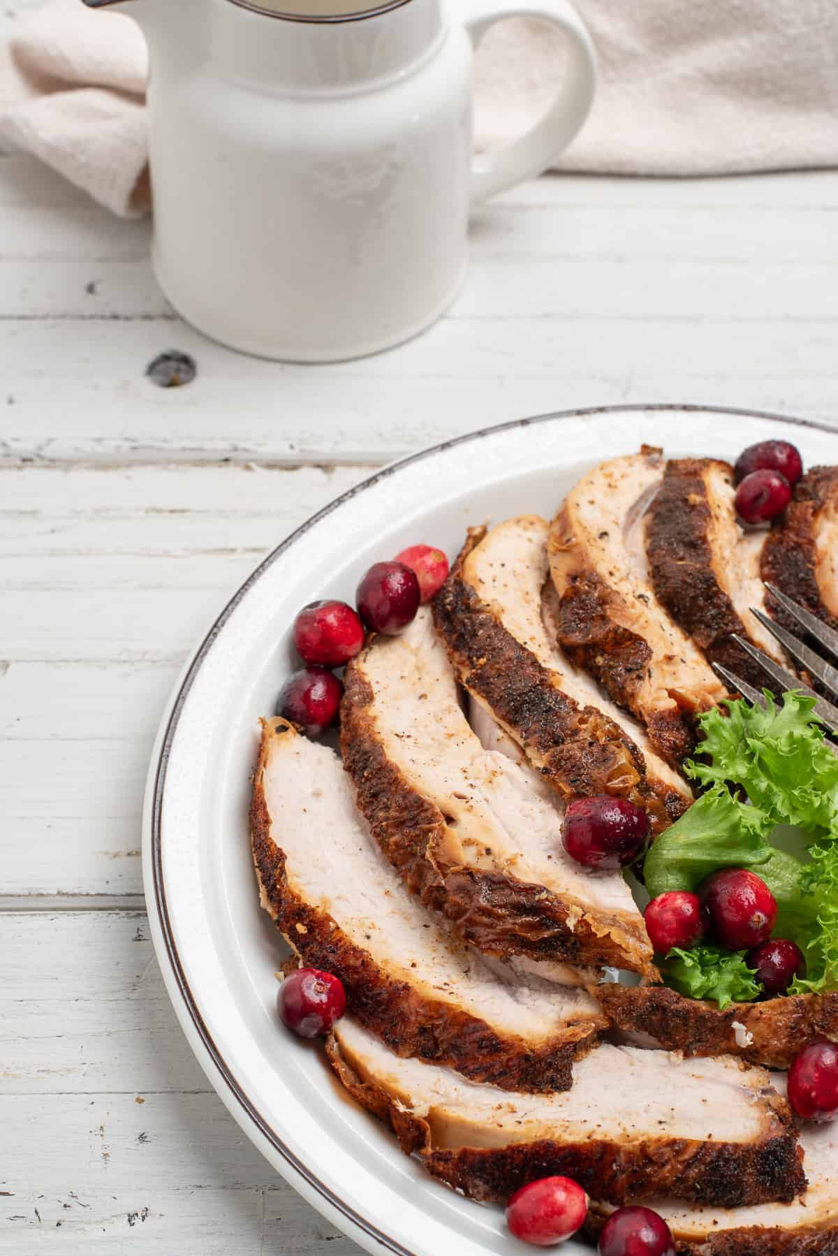 fried turkey on a white plate with fresh cranberries