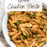 spicy chicken pasta in a white bowl with recipe title in text overlay