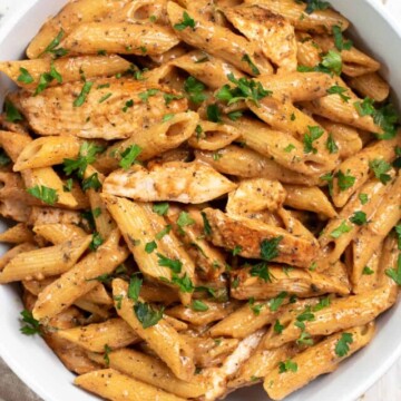 white bowl of spicy chicken pasta