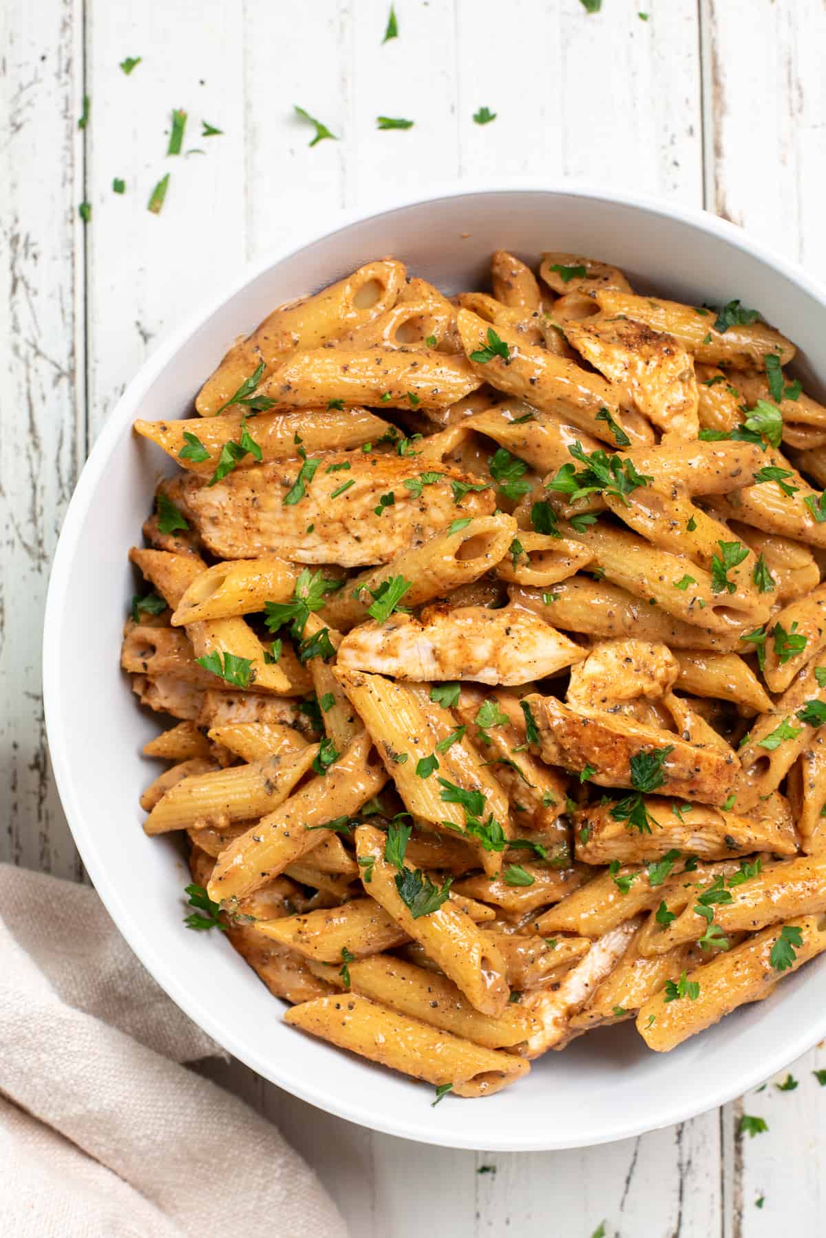 chicken pasta in a white bowl on a white background
