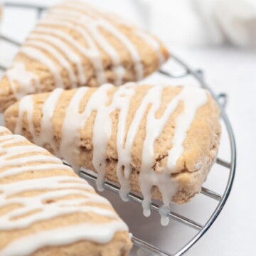 glazed cinnamon scones on rack.