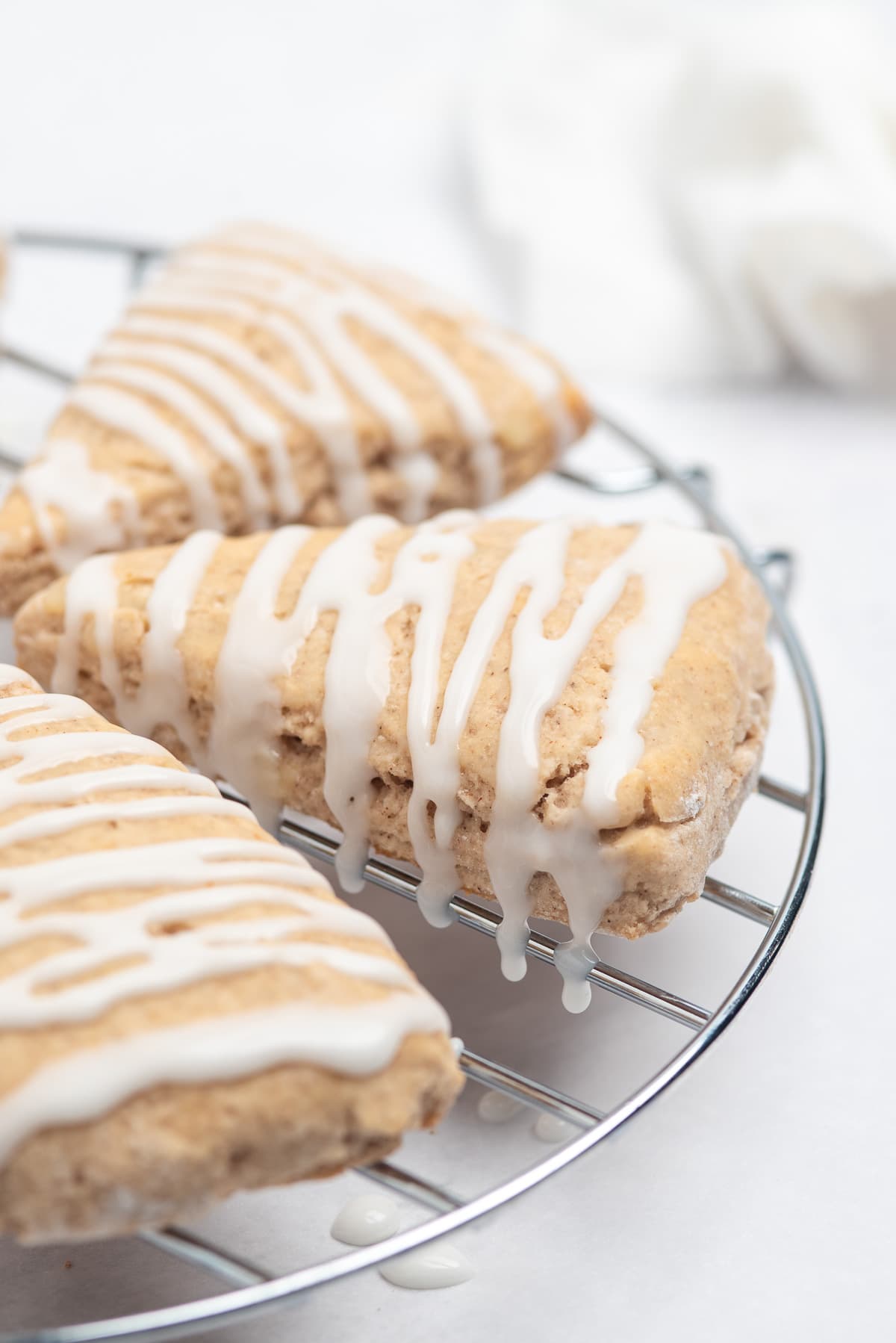 glazed cinnamon scones on rack. 