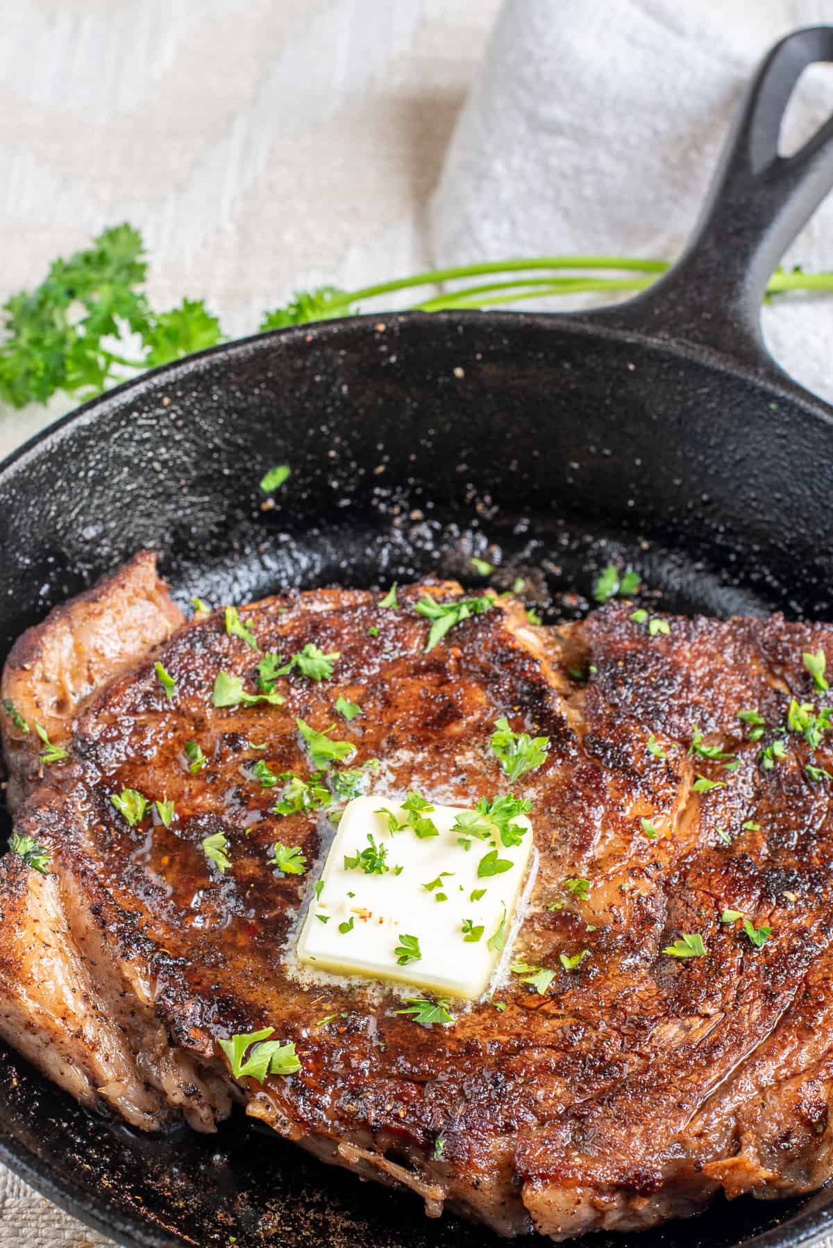 blackened ribeye steak in cast iron skillet.