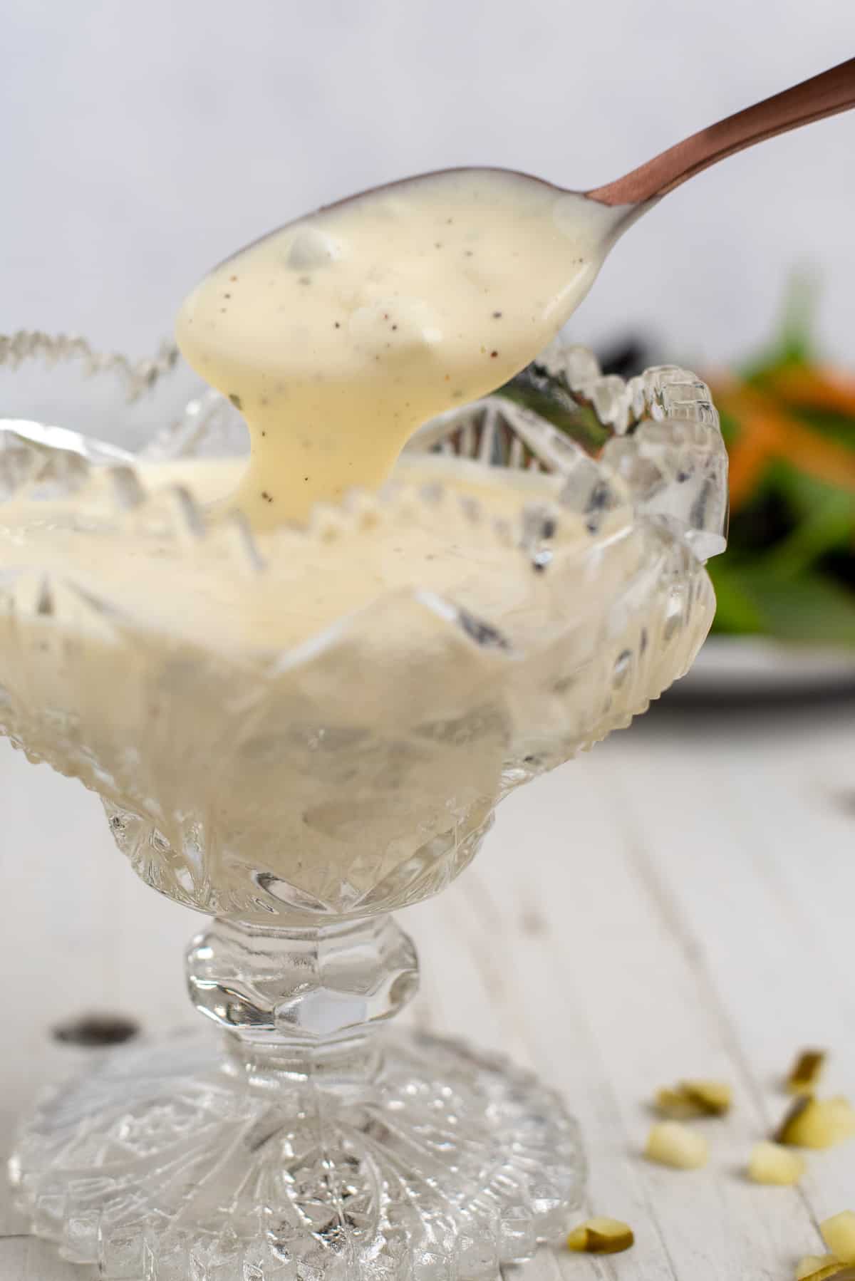 dill pickle ranch dressing in a glass dish with a spoon