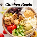 Greek chicken bowl on a white background with recipe title in text overlay.