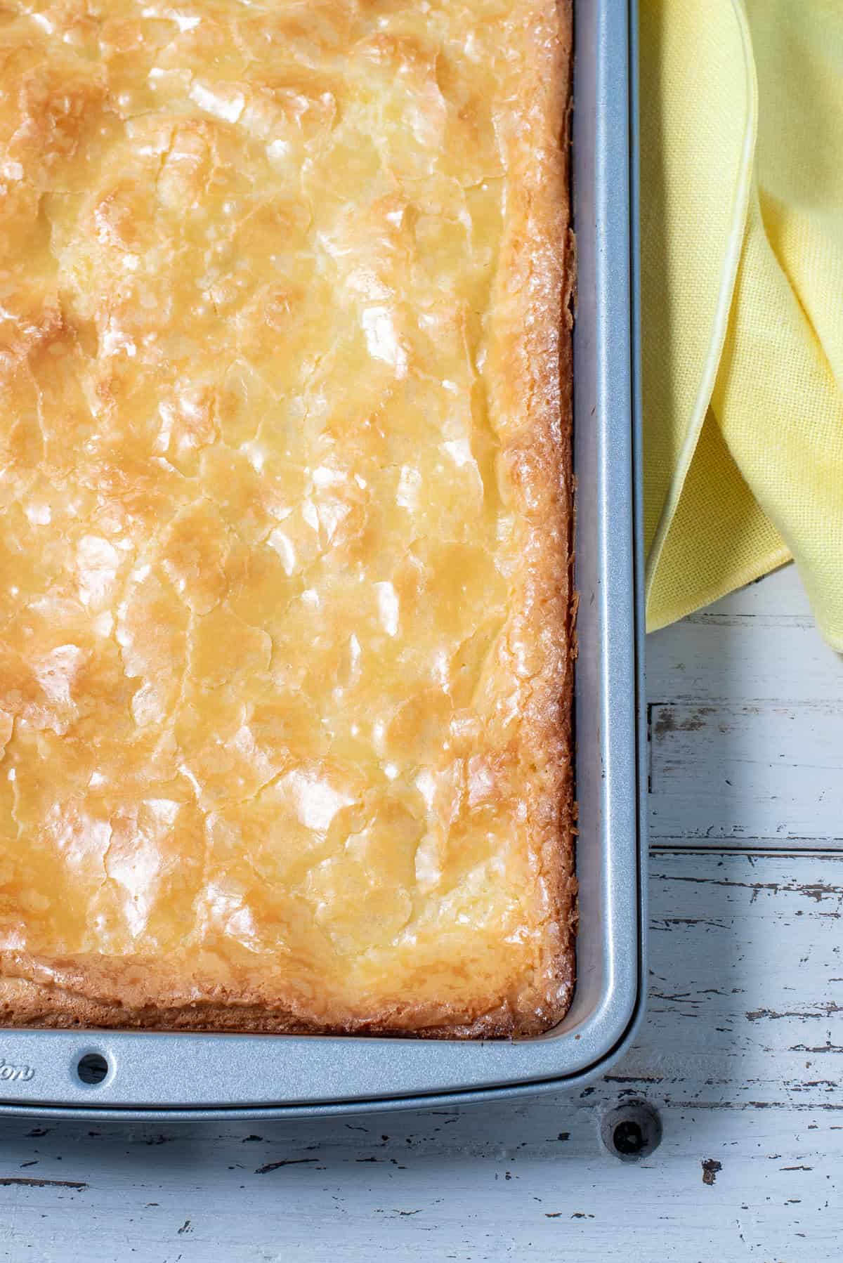 lemon gooey butter cake in pan before being cut.