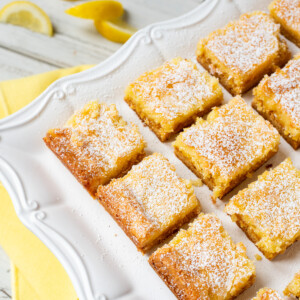 lemon gooey butter cake squares on plate.