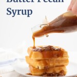 butter pecan syrup being poured over a stack of waffles with the recipe title in a text overlay