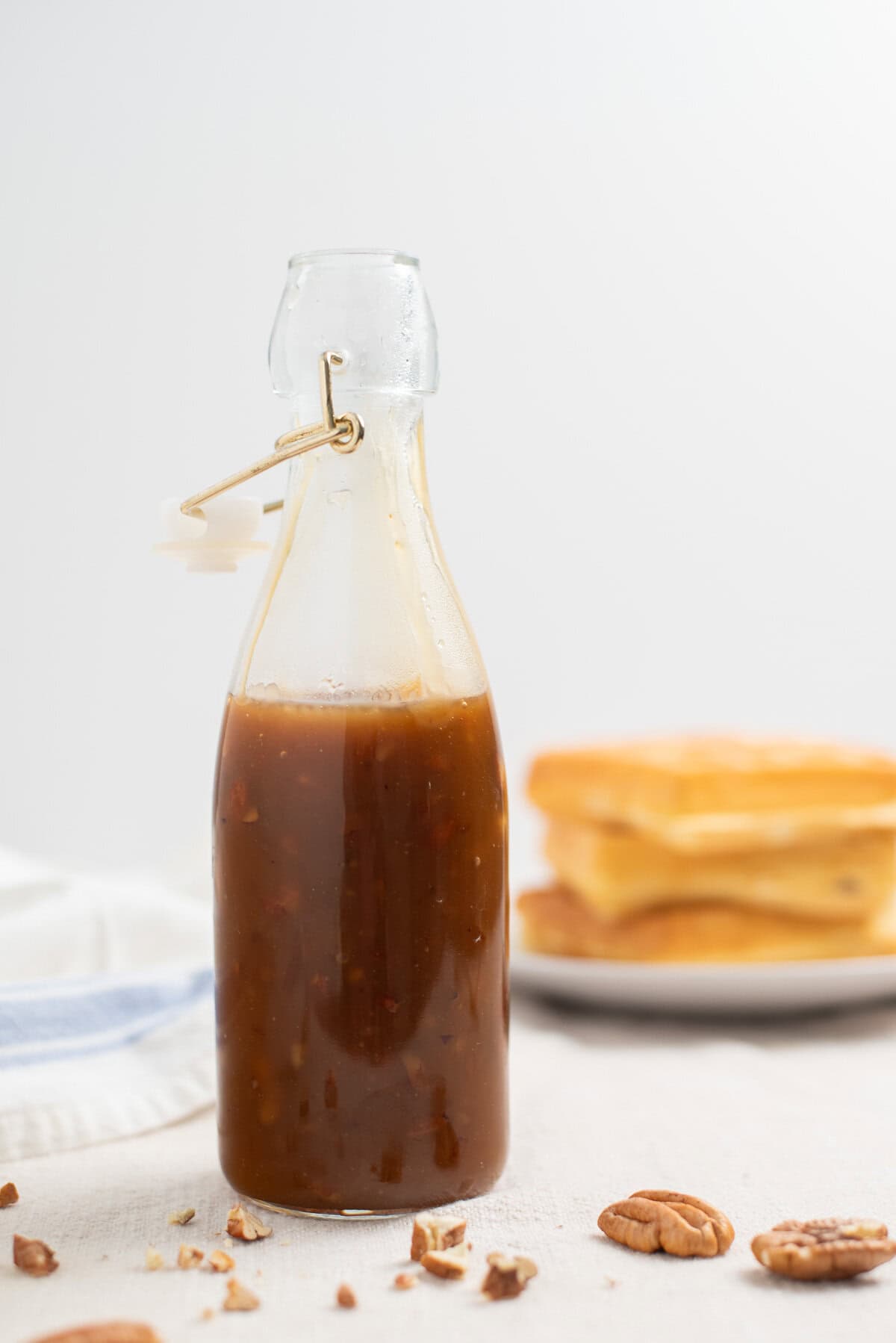 A glass jar of homemade butter pecan syrup