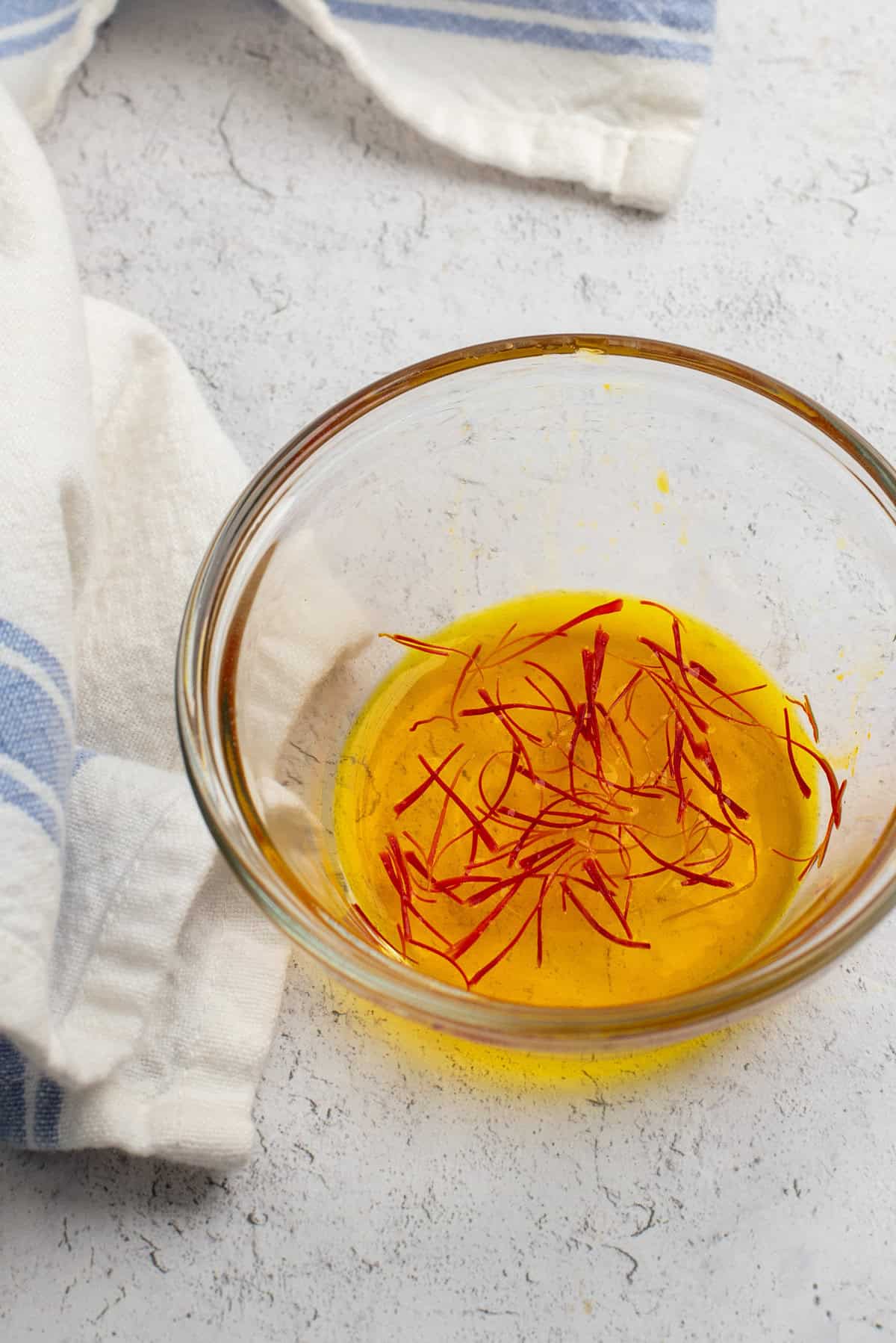 saffron threads in small bowl of water.