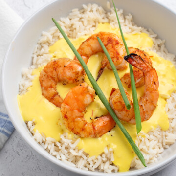 square image of shrimp and rice with saffron cream sauce.
