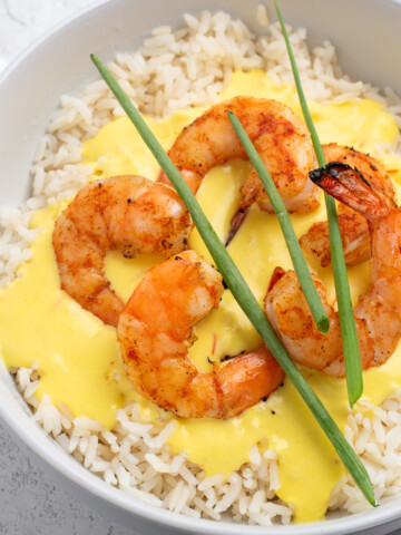 square image of shrimp and rice with saffron cream sauce.