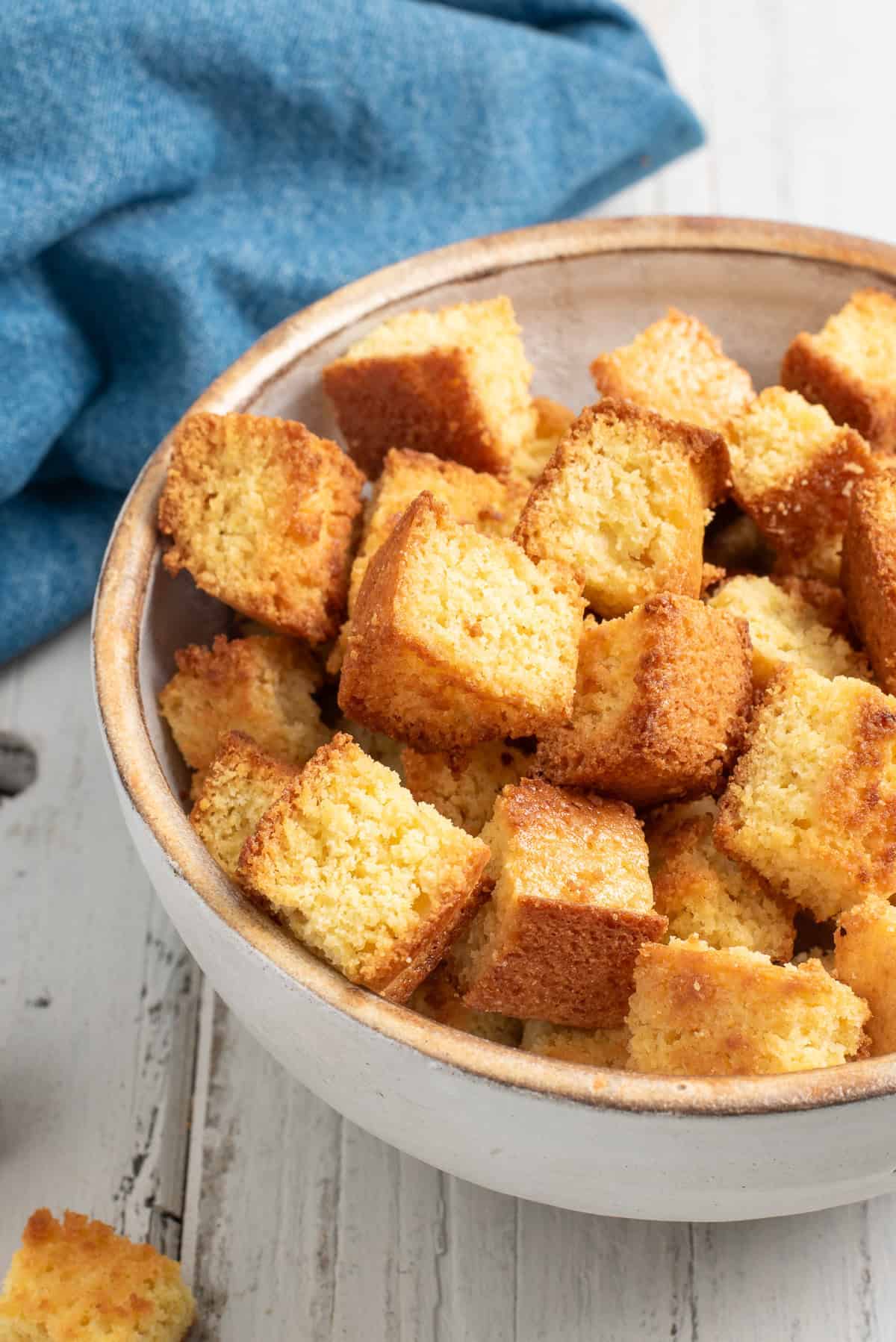 a white bowl of cornbread croutons