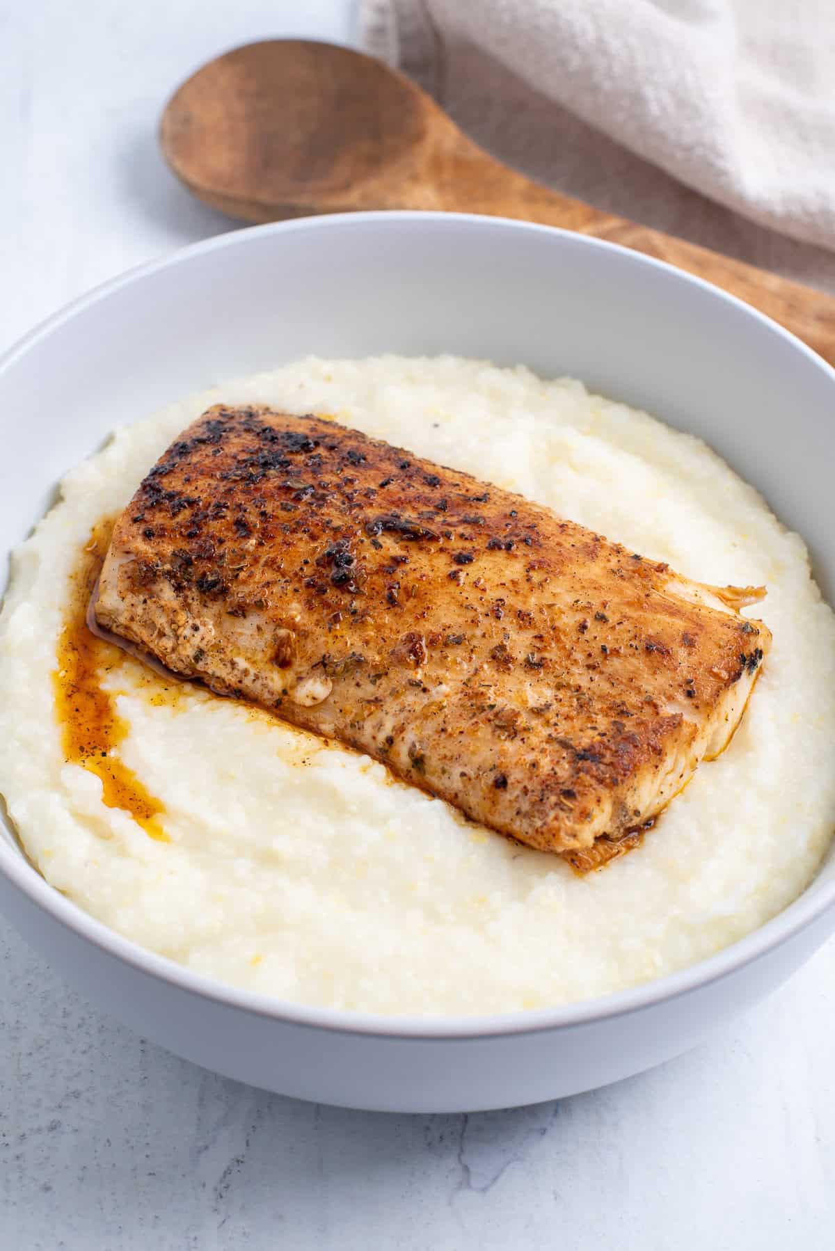 fish over grits with no garnish.