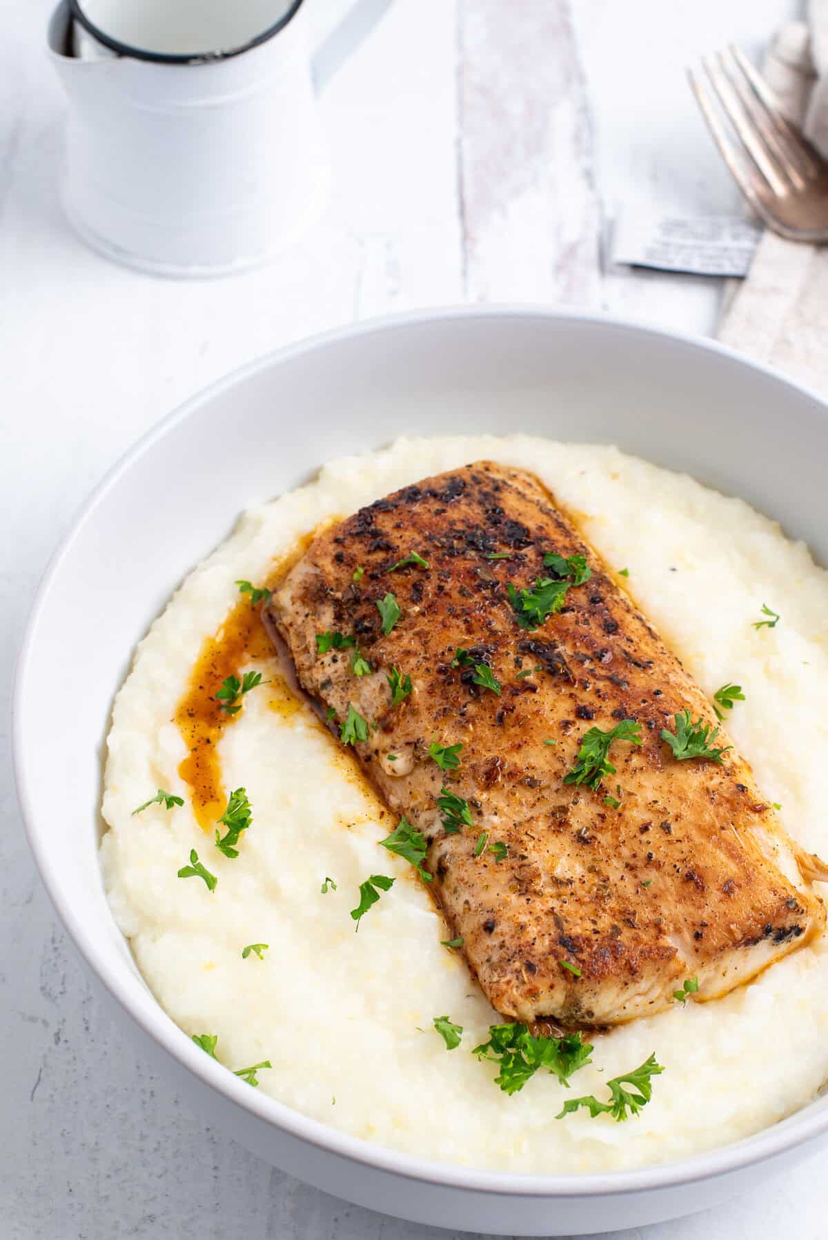 fish on a bowl of grits.