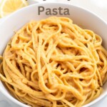 creamy cajun pasta in a white bowl with recipe title in text overlay