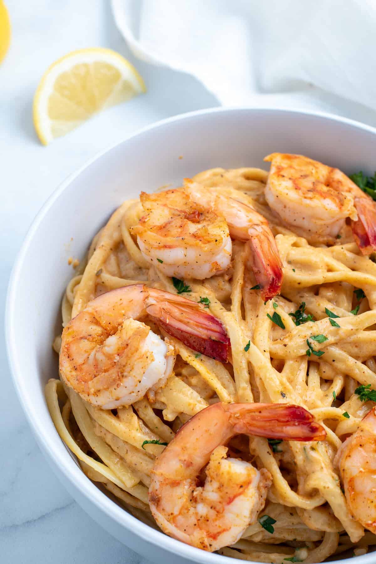 spicy cajun shrimp pasta in a white bowl