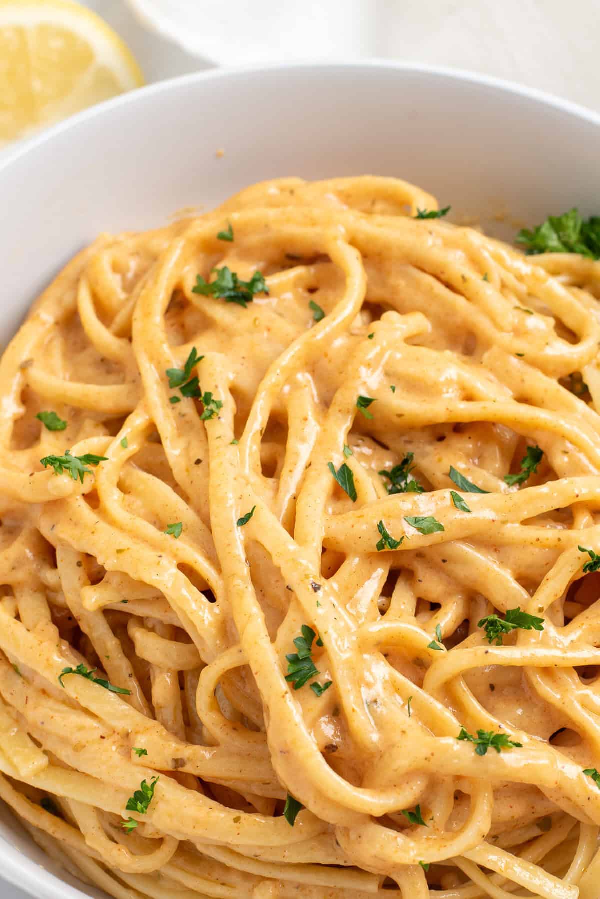 close up of spicy cajun chicken pasta sprinkled with fresh parsley