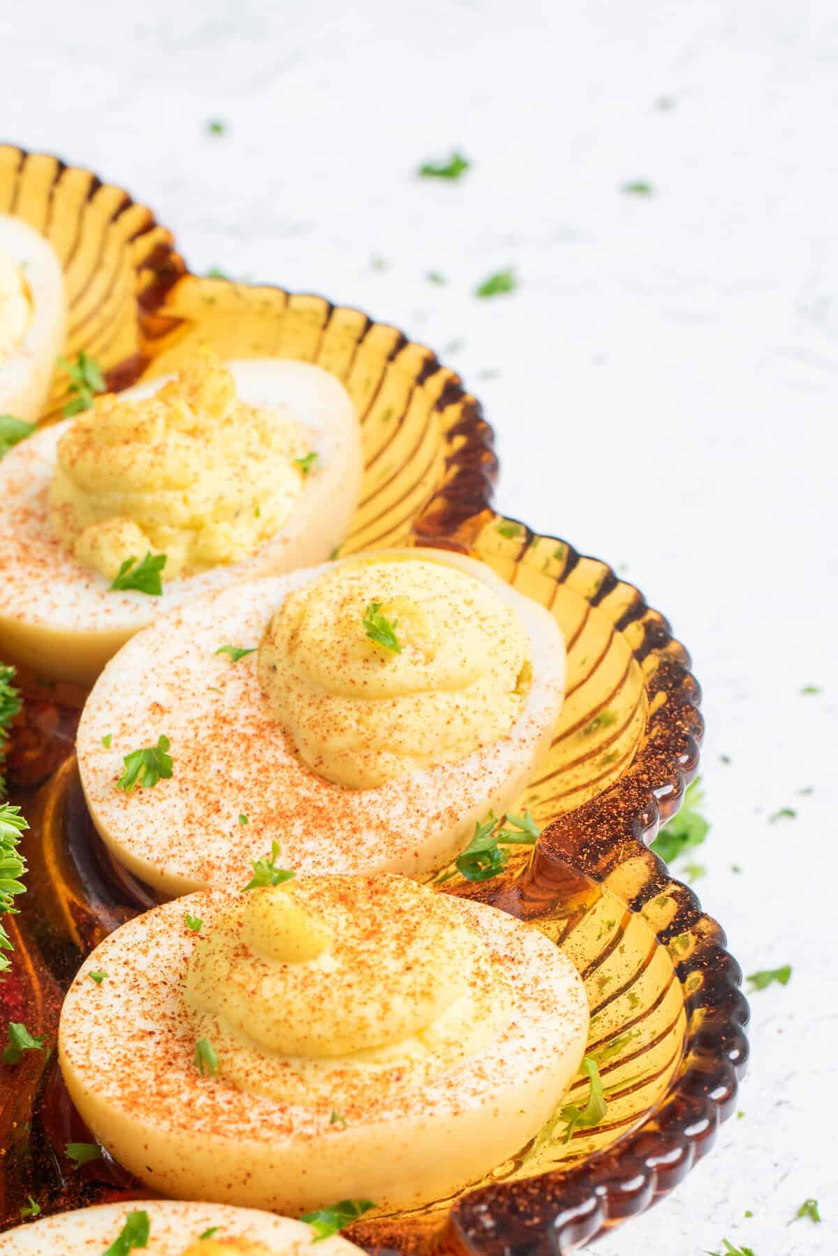 smoked deviled eggs on glass plate.