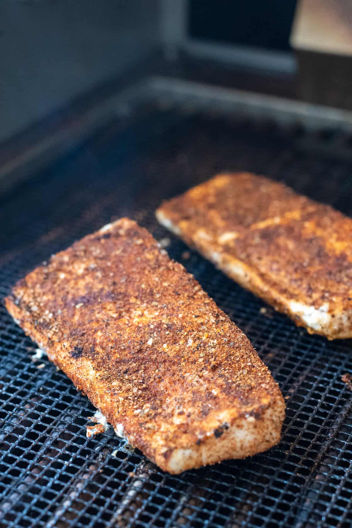 blackened grouper filets on grill.