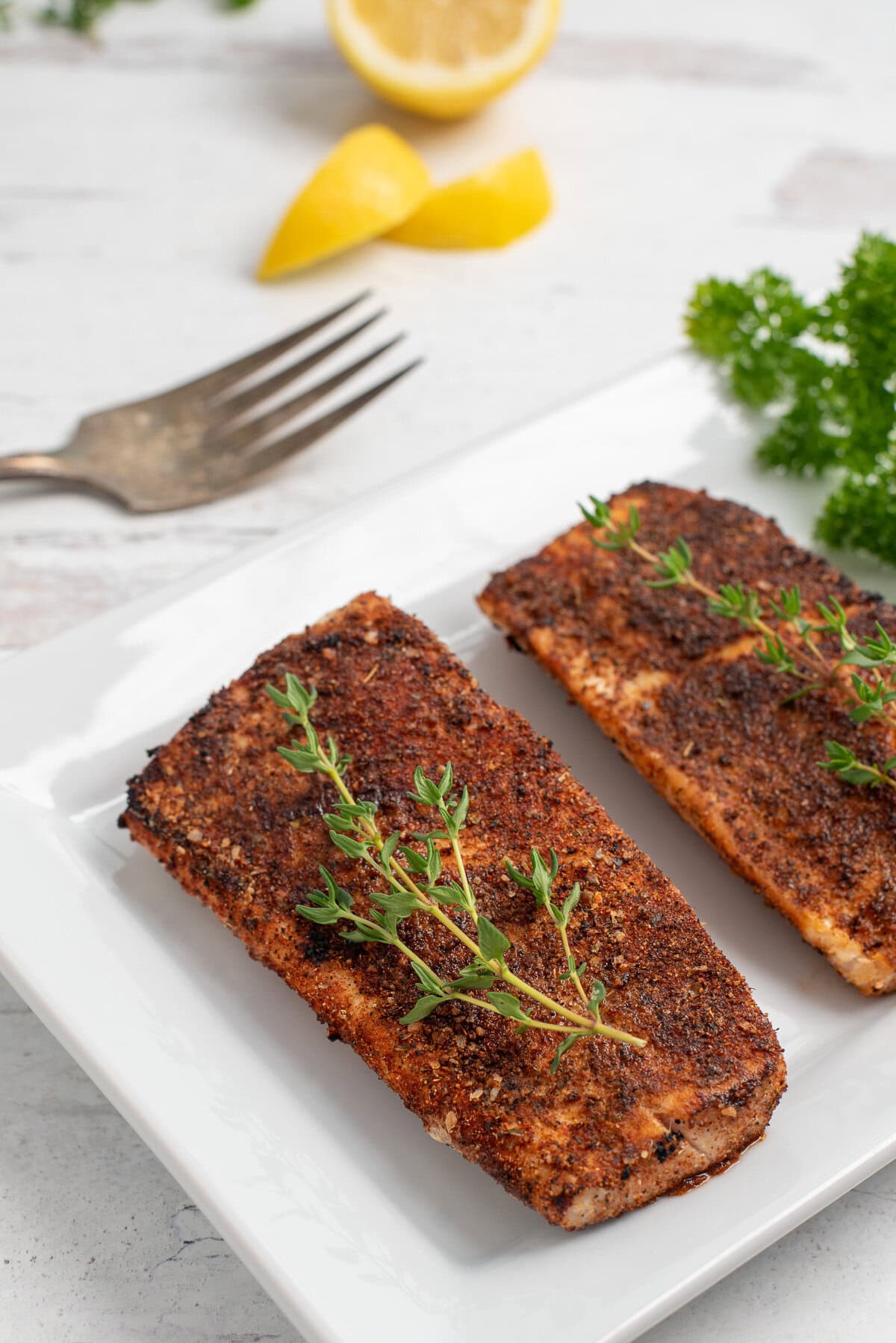 grouper filets that have been blackened with lemon.