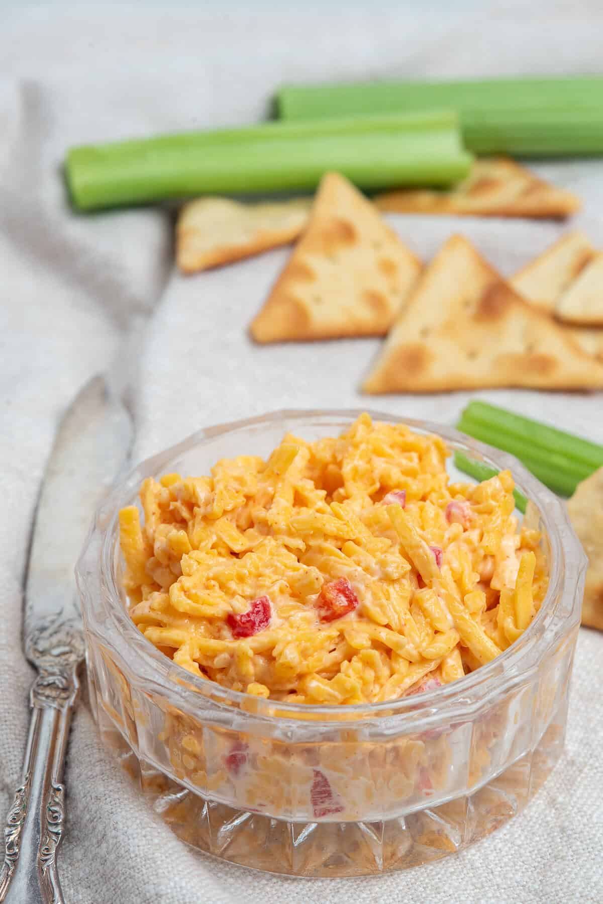 pimento cheese with crackers and celery behind.
