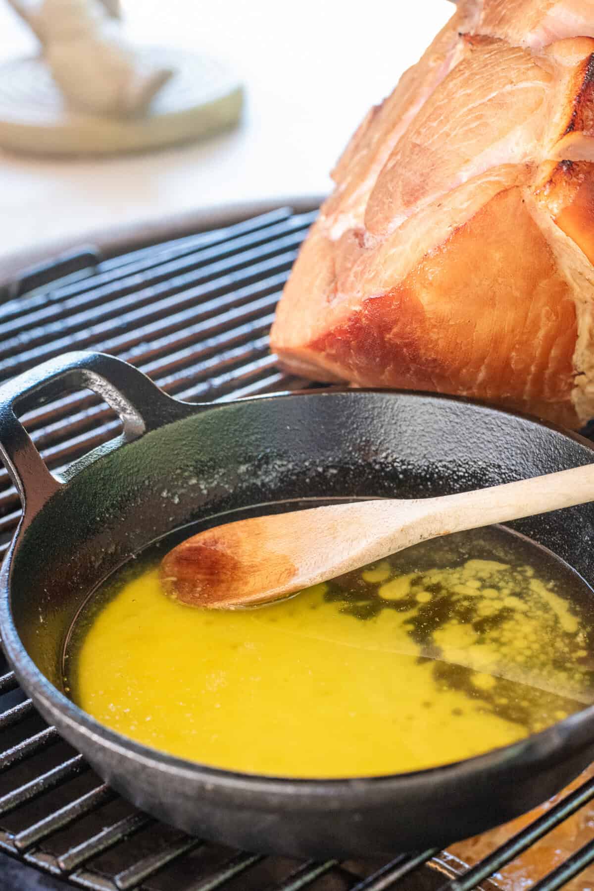 skillet of smoked butter on grill.