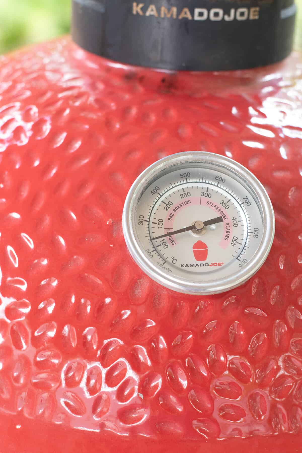 close up of thermometer on smoker.