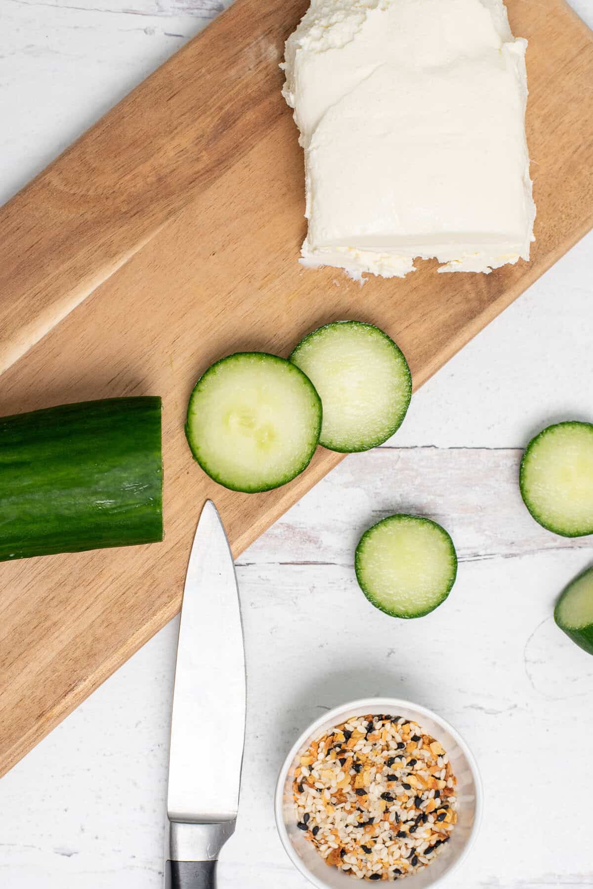 overhead shot of cream cheese, cucumber and seasoning.