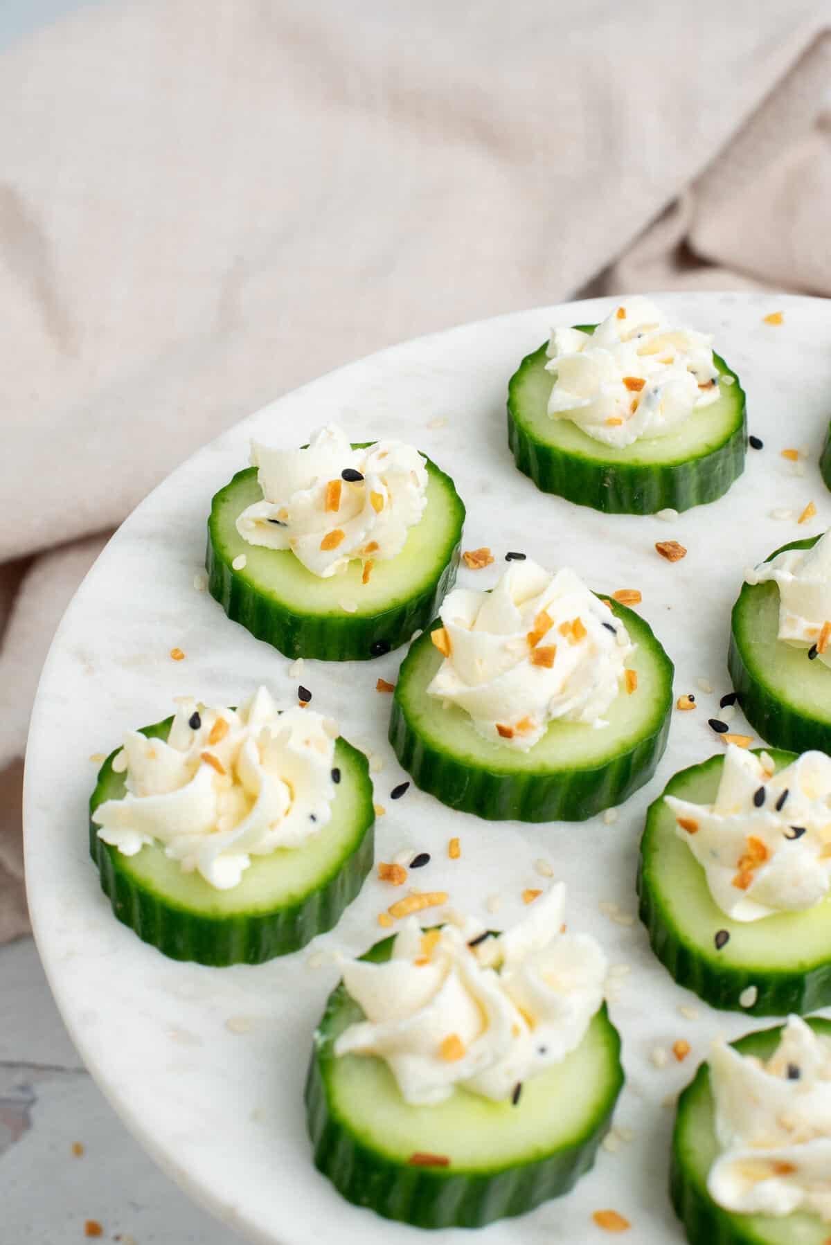 cream cheese cucumber bites on a white platter