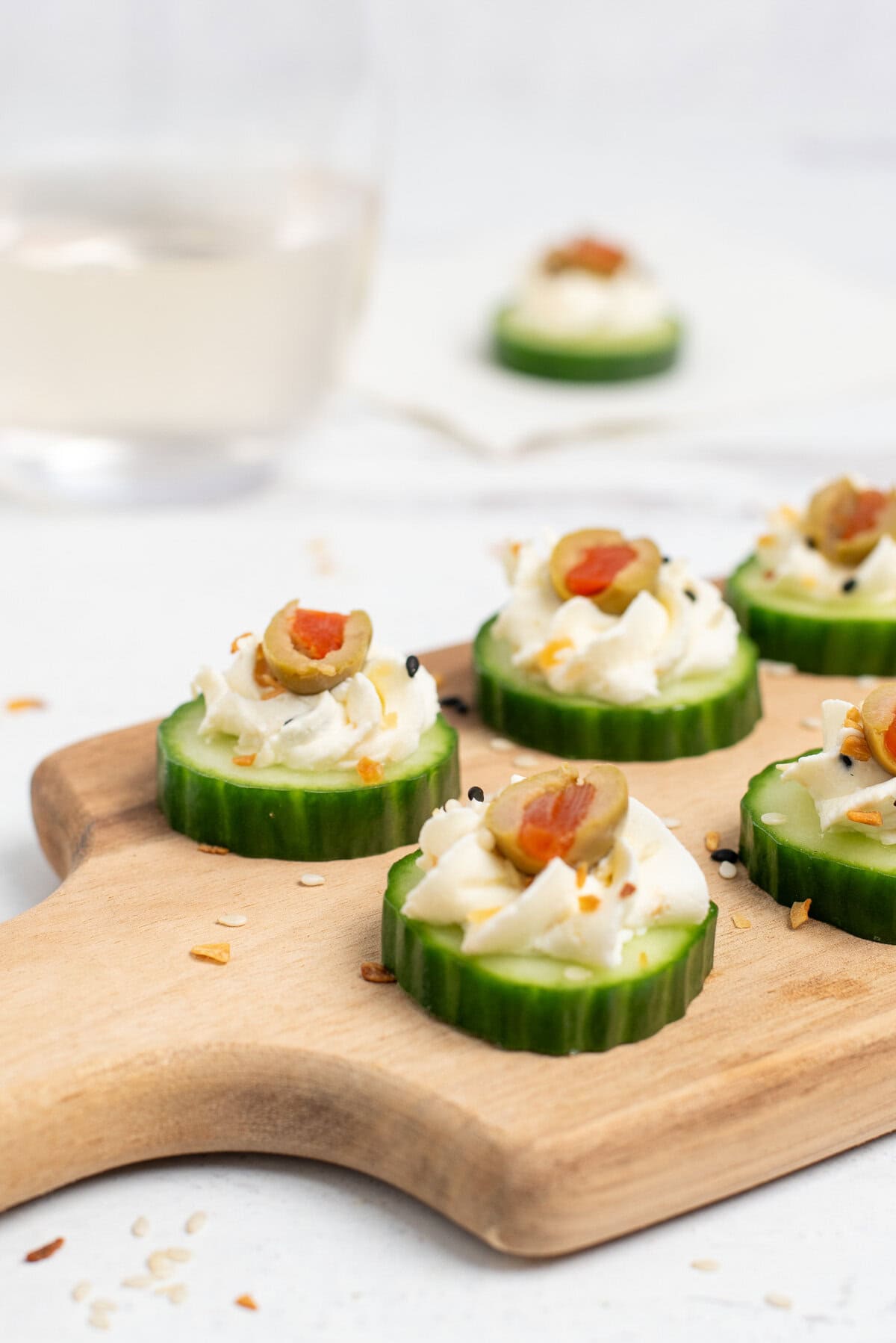 3 ingredient cucumber appetizers topped with olives.