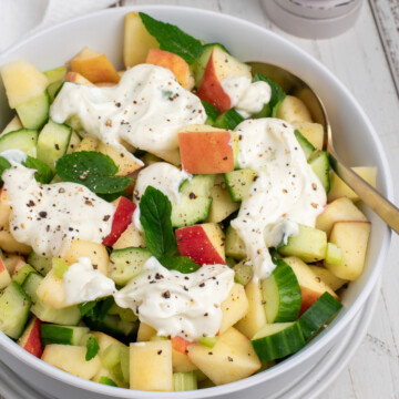 cucumber apple salad topped with yogurt dressing