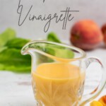 peach vinaigrette in a glass pitcher with recipe title in text overlay