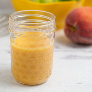 peach salad dressing in a glass mason jar