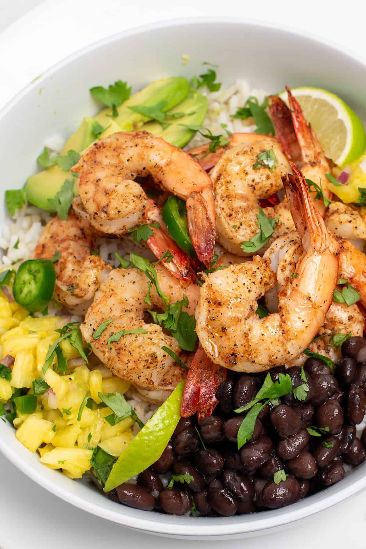 blackened shrimp bowls with cilantro, avocado, pineapple salsa, and lime