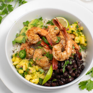 Blackened shrimp bowls with black beans, pineapple salsa, and avocado