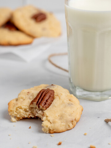 square image of coconut pecan cookies with bite out.