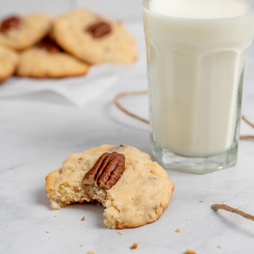 square image of coconut pecan cookies with bite out.