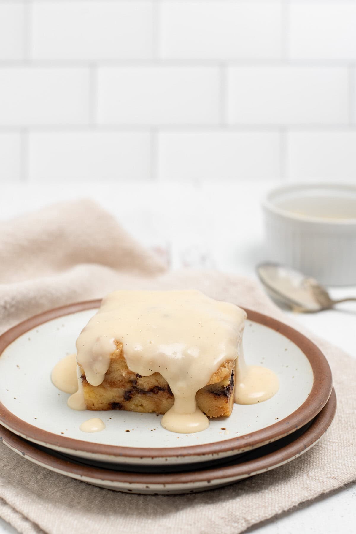 bread pudding on plate with bourbon sauce.