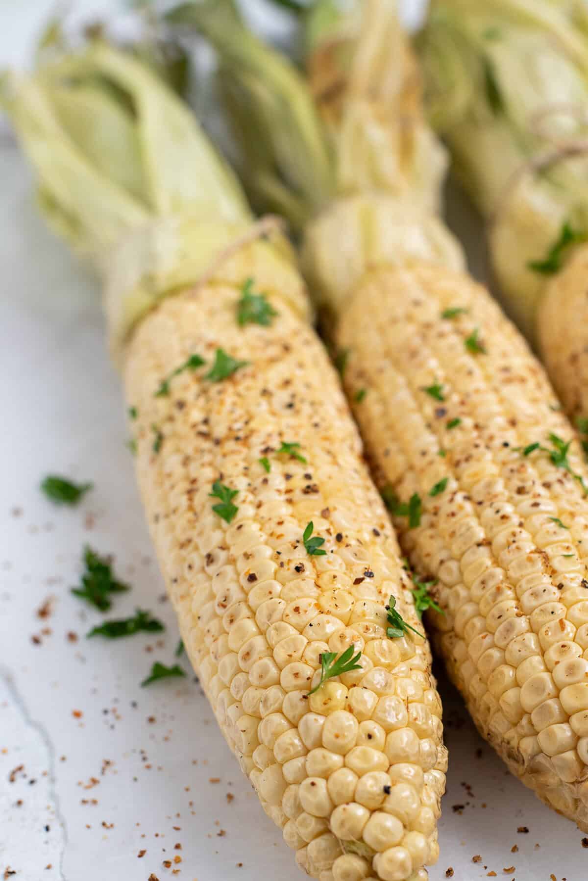 overhead shot of smoked corn with seasonings.