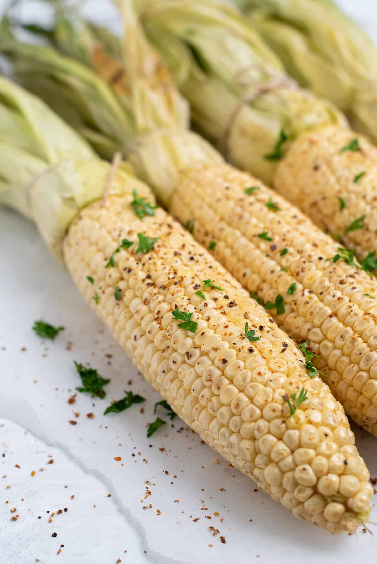 smoked corn on the cob with seasonings.