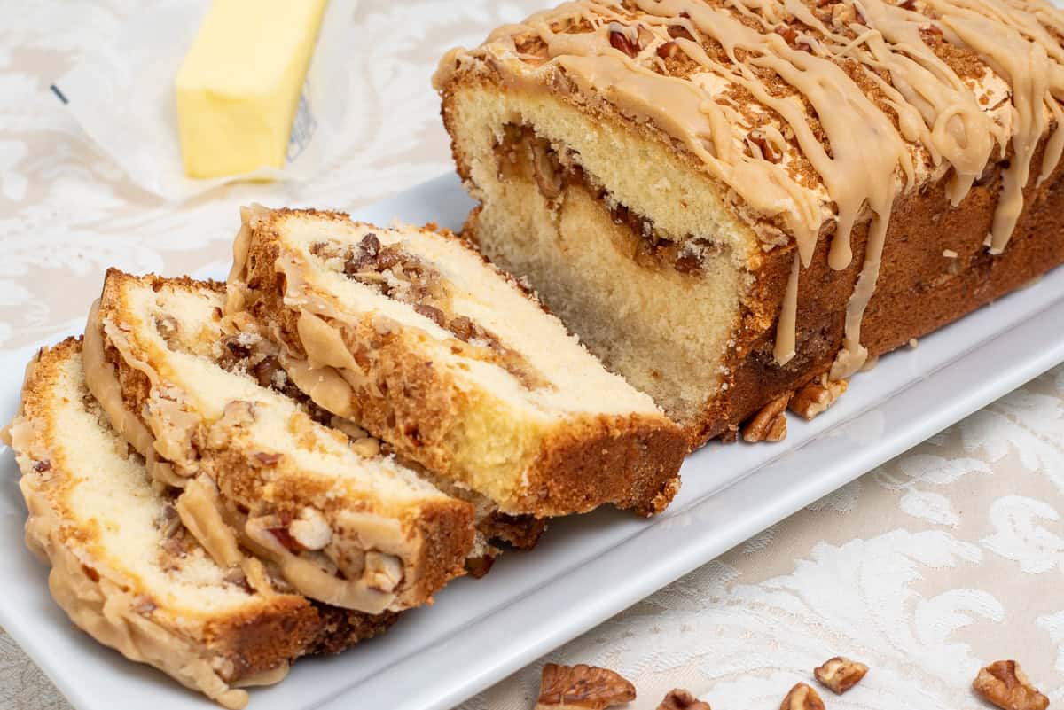 A butter pecan pound cake with 3 slices.