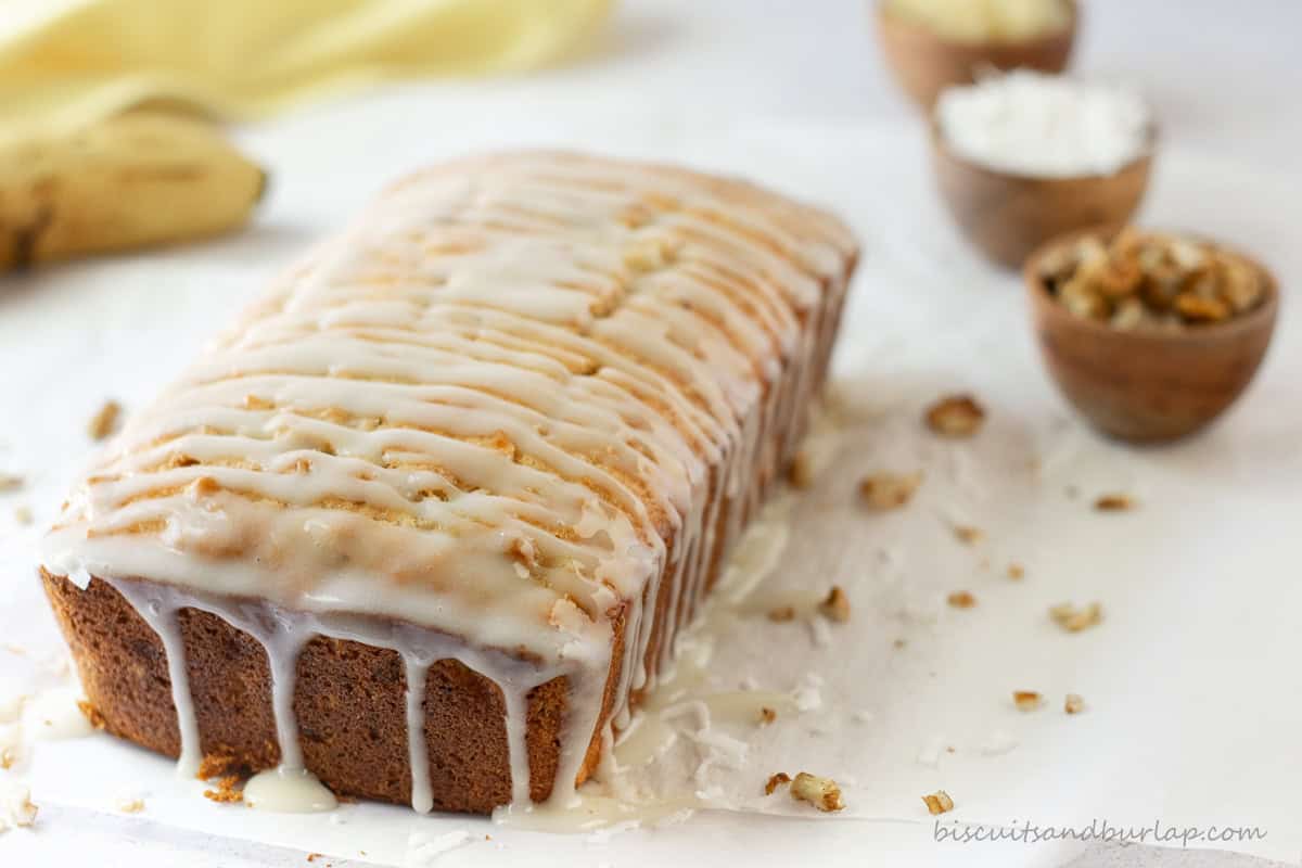 Hummingbird loaf break with cream cheese glaze dripping down the sides.
