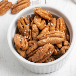 square image of honey roasted pecans in bowl.